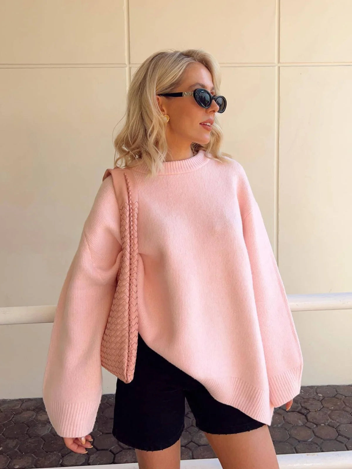 Women's pink round neck pullover with long sleeves, crafted from soft cotton blend for comfort and casual style.