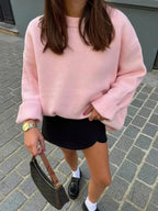 Women's pink round neck pullover made from soft cotton, featuring long sleeves and a relaxed fit for everyday comfort.