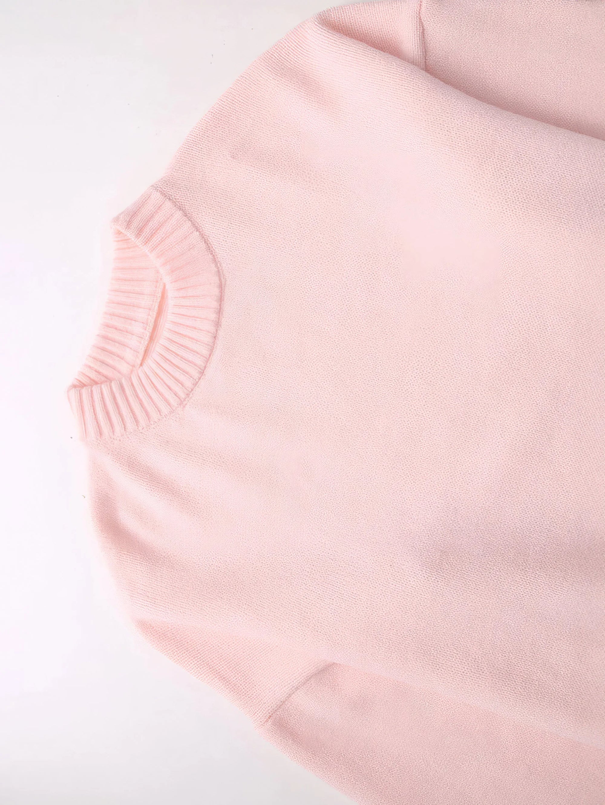 Women's pink round neck pullover made of soft cotton, featuring long sleeves and a relaxed fit for everyday comfort.