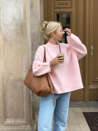Women's pink round neck pullover with long sleeves, made from soft cotton blend for comfort and casual style.