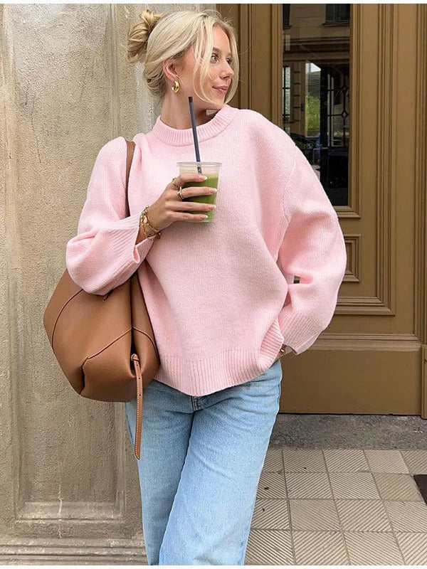 Women's pink pullover with round neck and long sleeves, crafted from soft cotton knit for warmth and comfort.