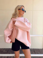 Women's pink round neck pullover, made of soft cotton, featuring long sleeves and a casual, comfortable fit.
