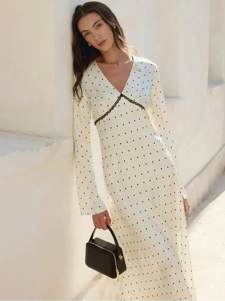 Women's V-neck maxi dress in polka dots, crafted from soft fabric, featuring delicate lace details for added elegance.