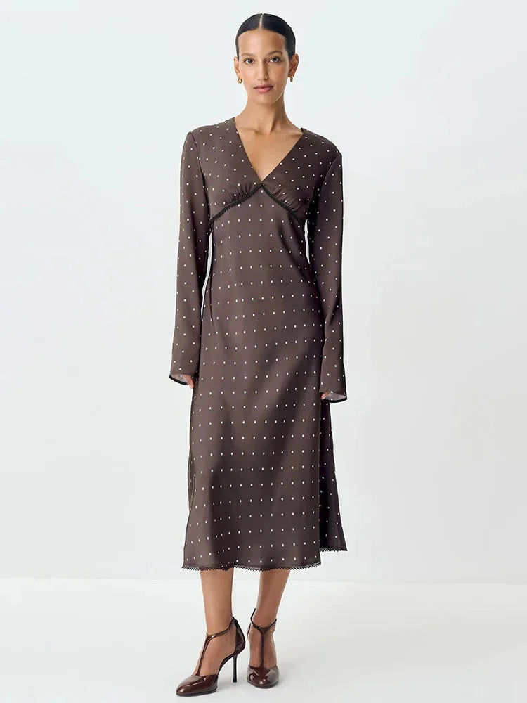 Women's V-neck maxi dress in polka dot pattern, featuring delicate lace details and a flowing silhouette, made from…