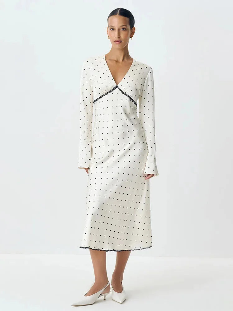 Women's polka dot V-neck maxi dress made of soft fabric, featuring delicate lace details and a flowy silhouette for comfort.