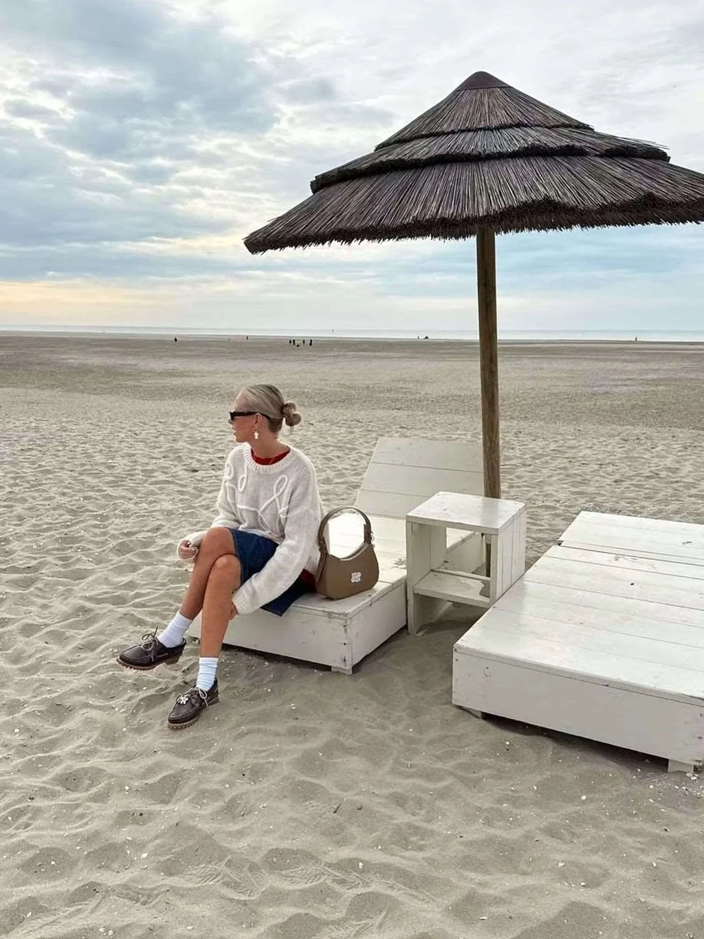 Women's pullover sweater featuring a textured swirl design, made from soft knit material for warmth and comfort.