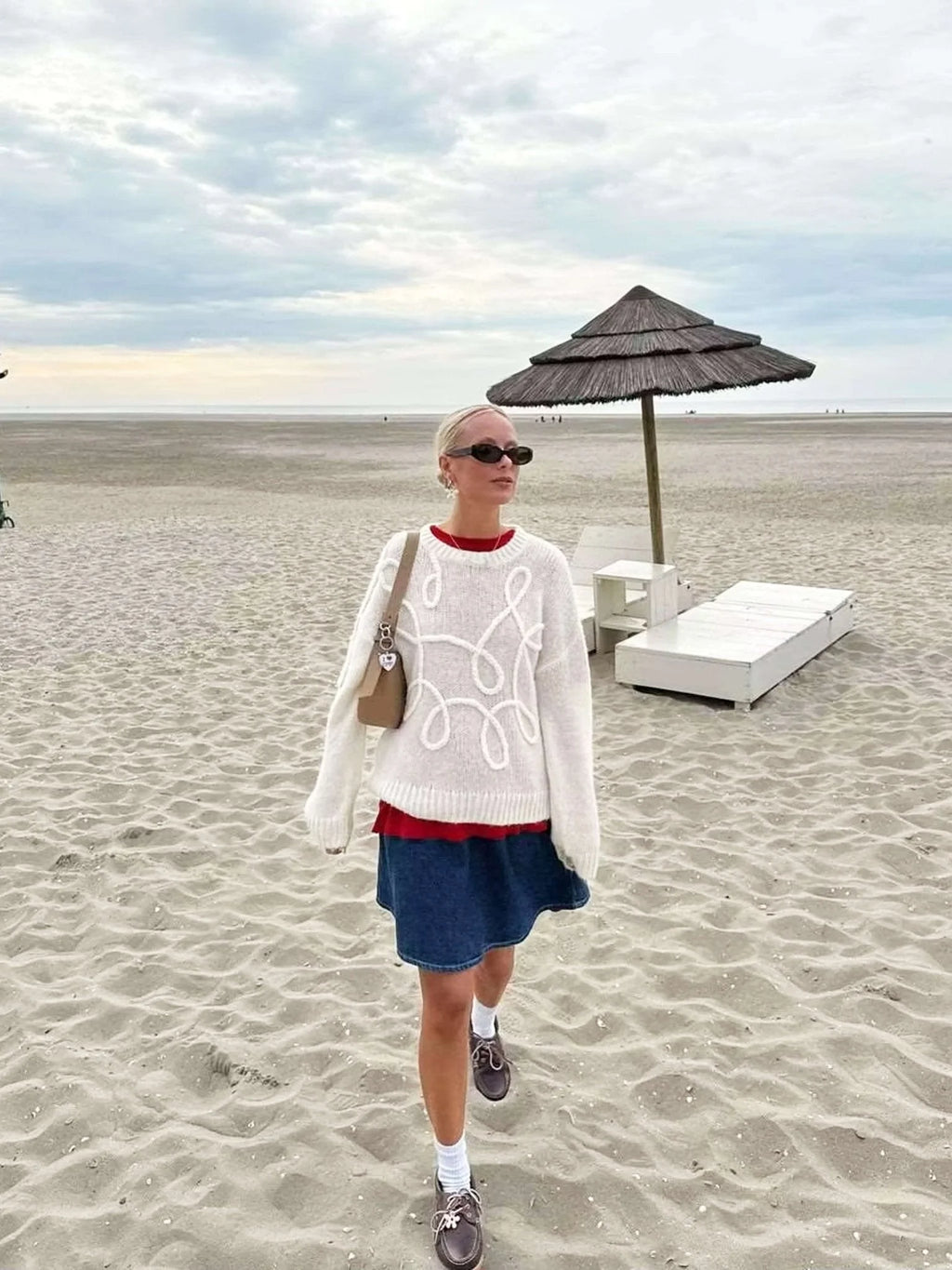 Women’s pullover sweater featuring a soft knit texture with a swirl design for added visual interest and warmth.