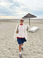 Women’s pullover sweater featuring a soft knit texture with a swirl design for added visual interest and warmth.