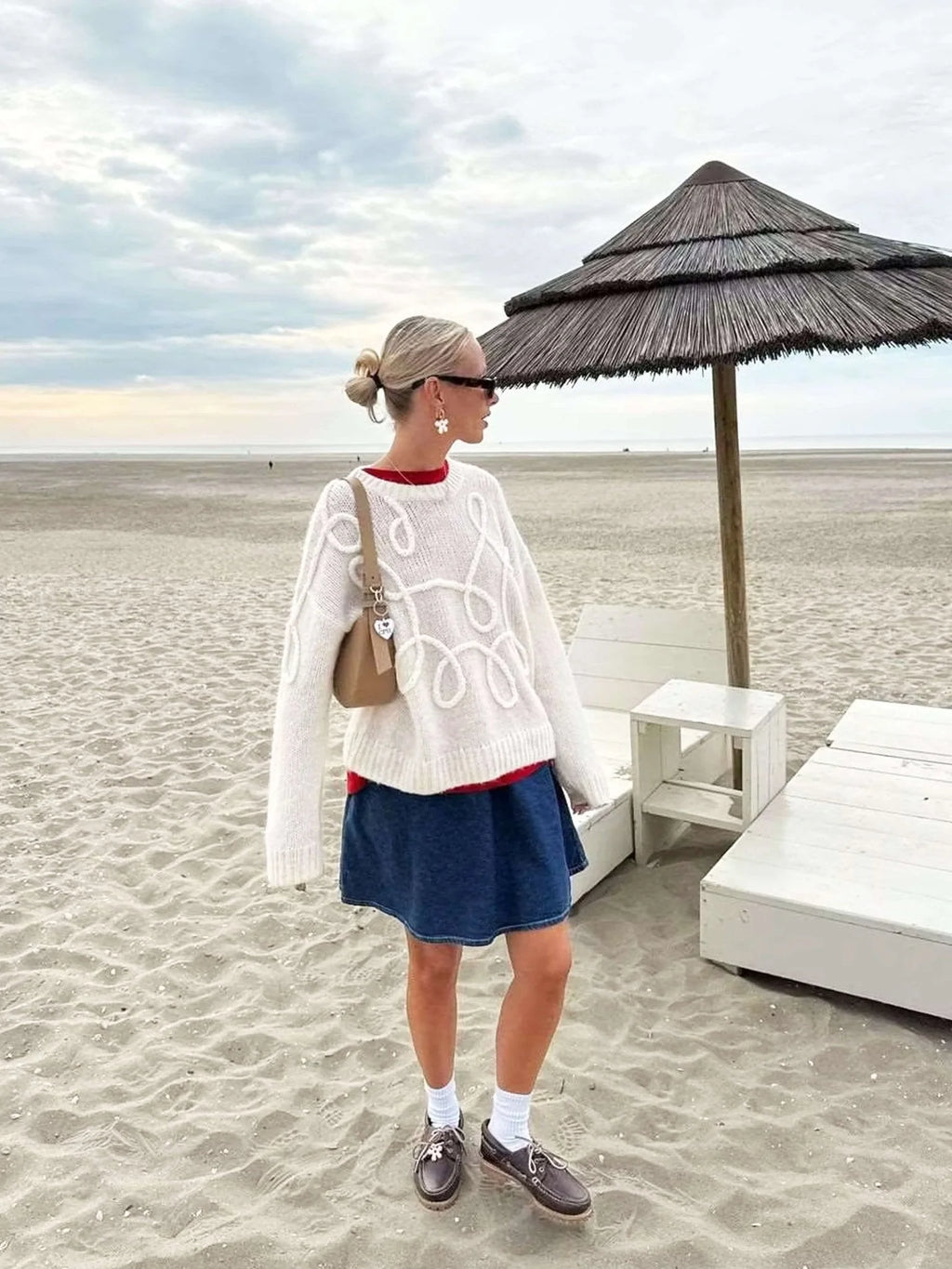 Women's pullover sweater featuring a textured swirl design, made from soft, breathable fabric for comfort and warmth.