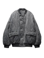Women's quilted bomber jacket with snap closures, featuring a soft fabric, ribbed cuffs, and a stylish cropped design.