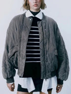 Women's quilted bomber jacket in navy, featuring snap closures and ribbed cuffs for a comfortable fit in cool weather.