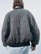 Women's quilted bomber jacket in durable fabric with snap closures and ribbed cuffs for a comfortable fit.
