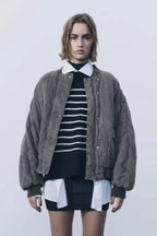 Women's quilted bomber jacket with snap closures, featuring a warm fabric, ribbed cuffs, and a stylish, streamlined…