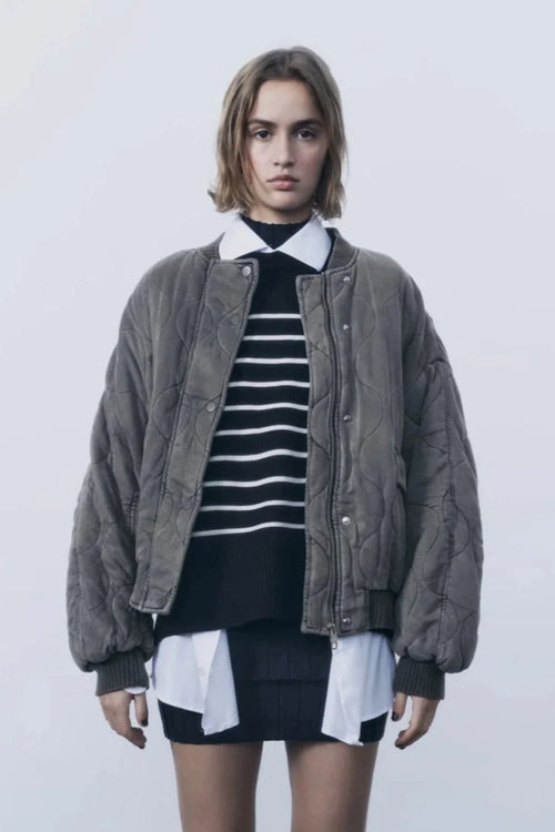 Women's quilted bomber jacket with snap closures, featuring a warm fabric, ribbed cuffs, and a stylish, streamlined…