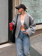 Women's relaxed button-up cardigan made from soft cotton blend, featuring a cozy fit and versatile design for everyday wear.