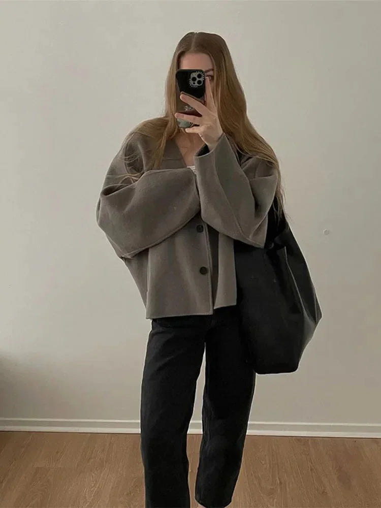 Women's relaxed button-up cardigan made from soft knit fabric, featuring long sleeves and a cozy, easy fit for casual wear.
