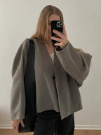 Women's button-up cardigan in soft knit, featuring a relaxed fit and cozy feel, perfect for layering in cooler weather.