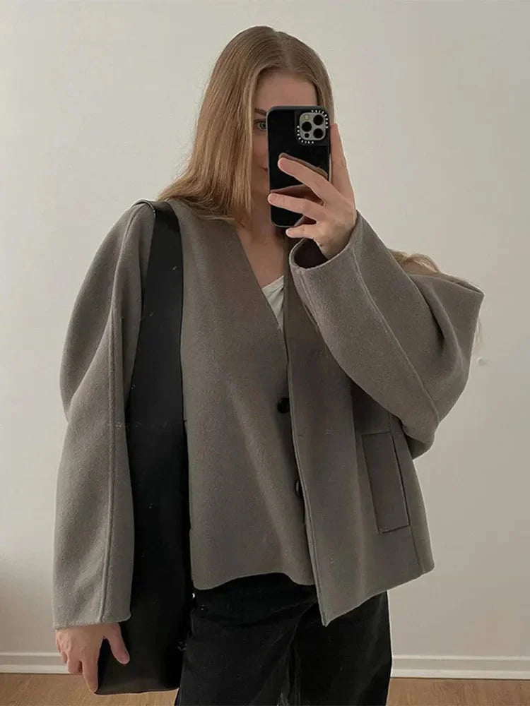 Women's button-up cardigan in soft knit, featuring a relaxed fit and cozy feel, perfect for layering in cooler weather.