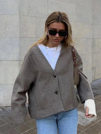 Women's relaxed button-up cardigan, featuring a cozy fit and soft knit material, perfect for layering in cool weather.