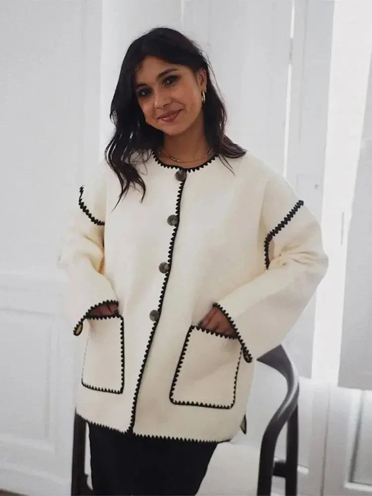 Women's relaxed fit cardigan crafted from soft cotton, featuring unique contrast stitching for a stylish, casual look.