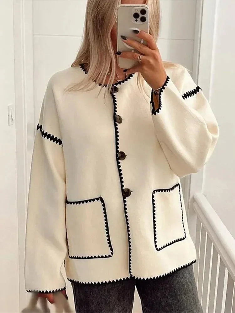 Women's relaxed fit cardigan in soft knit with contrast stitching, featuring an open front and side pockets for added…