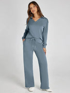 Women's relaxed-fit long-sleeve top in soft cotton paired with wide-leg pants, featuring a comfortable and casual design.