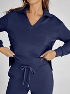 Women's relaxed-fit long-sleeve top in soft cotton, paired with wide-leg pants for a comfy, casual look.
