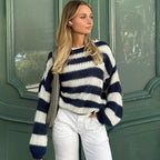 Women's relaxed fit striped knit pullover sweater made from soft cotton-blend fabric, featuring a comfortable oversized…