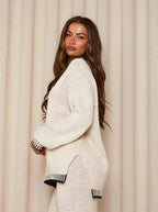 Cozy women's relaxed fit sweater and pants set made of soft cotton blend, featuring a minimalist design and comfortable fit.