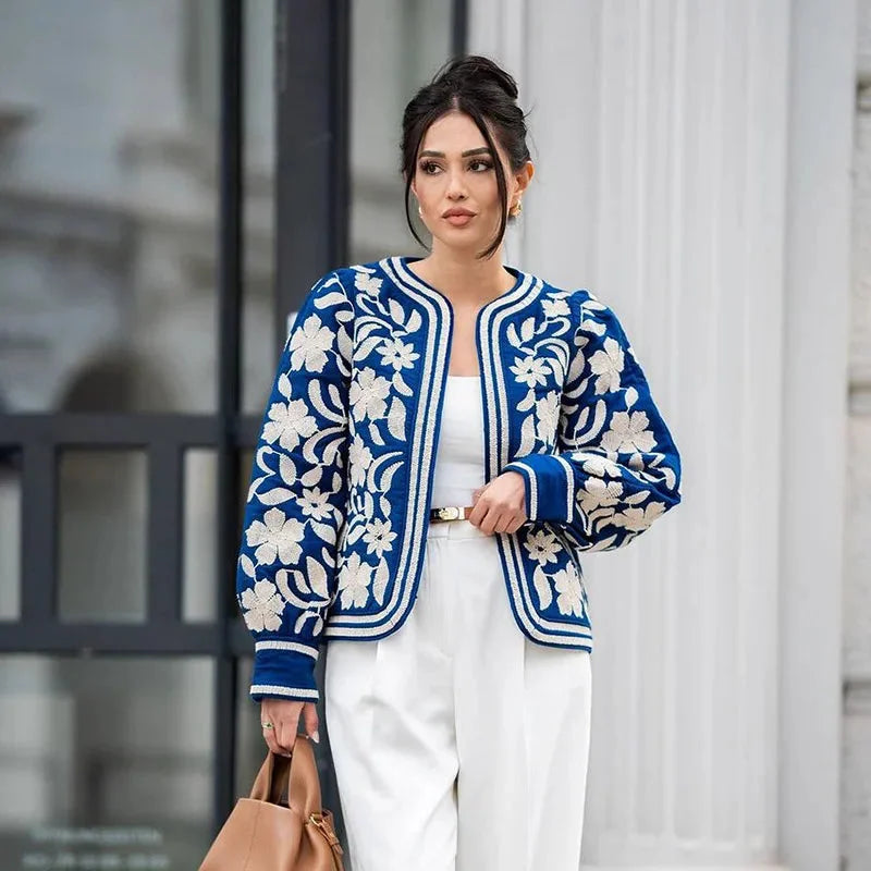 Alt text: Women's retro boho quilted jacket in soft fabric with a colorful patchwork design and button closures.