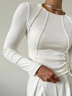 Women's ribbed long sleeve top featuring detailed stitching, made of soft cotton blend for comfort and style.