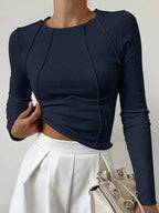 Women's long sleeve ribbed top in cotton blend with detailed stitching and a fitted design for comfort and versatility.