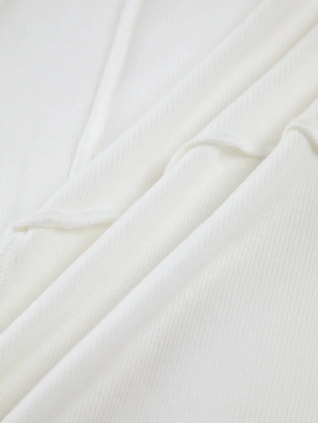 Women's ribbed long sleeve top featuring detailed stitching, made from soft cotton for comfort and a fitted silhouette.
