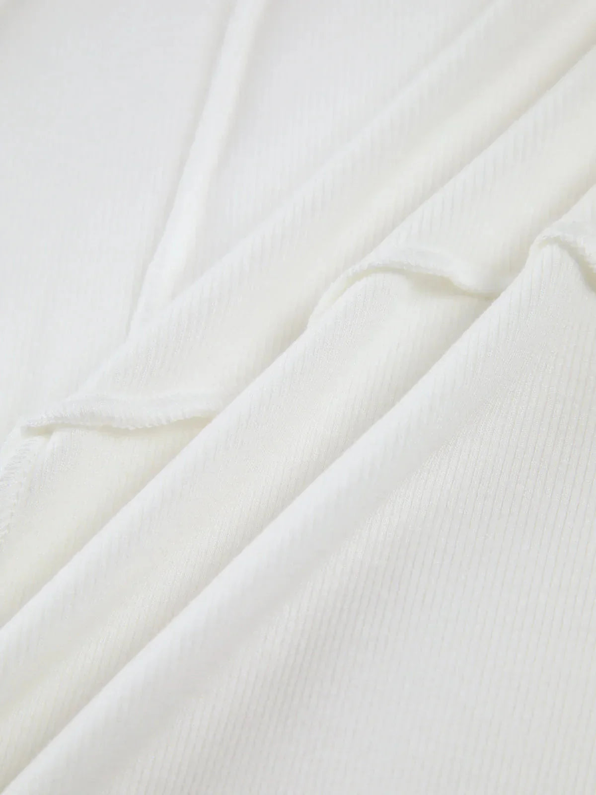 Women's ribbed long sleeve top featuring detailed stitching, made from soft cotton for comfort and a fitted silhouette.