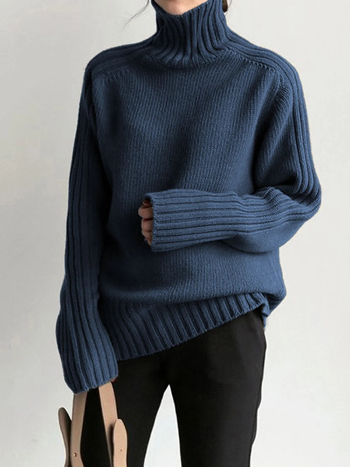 Women's ribbed mock neck knit sweater made from soft, breathable fabric with a fitted silhouette and textured detailing.