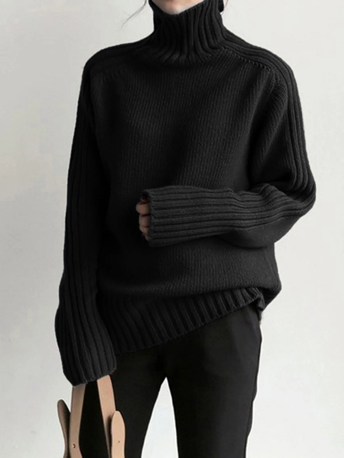 Women's ribbed mock neck knit sweater made from soft fabric, featuring a fitted silhouette and elegant ribbed texture.