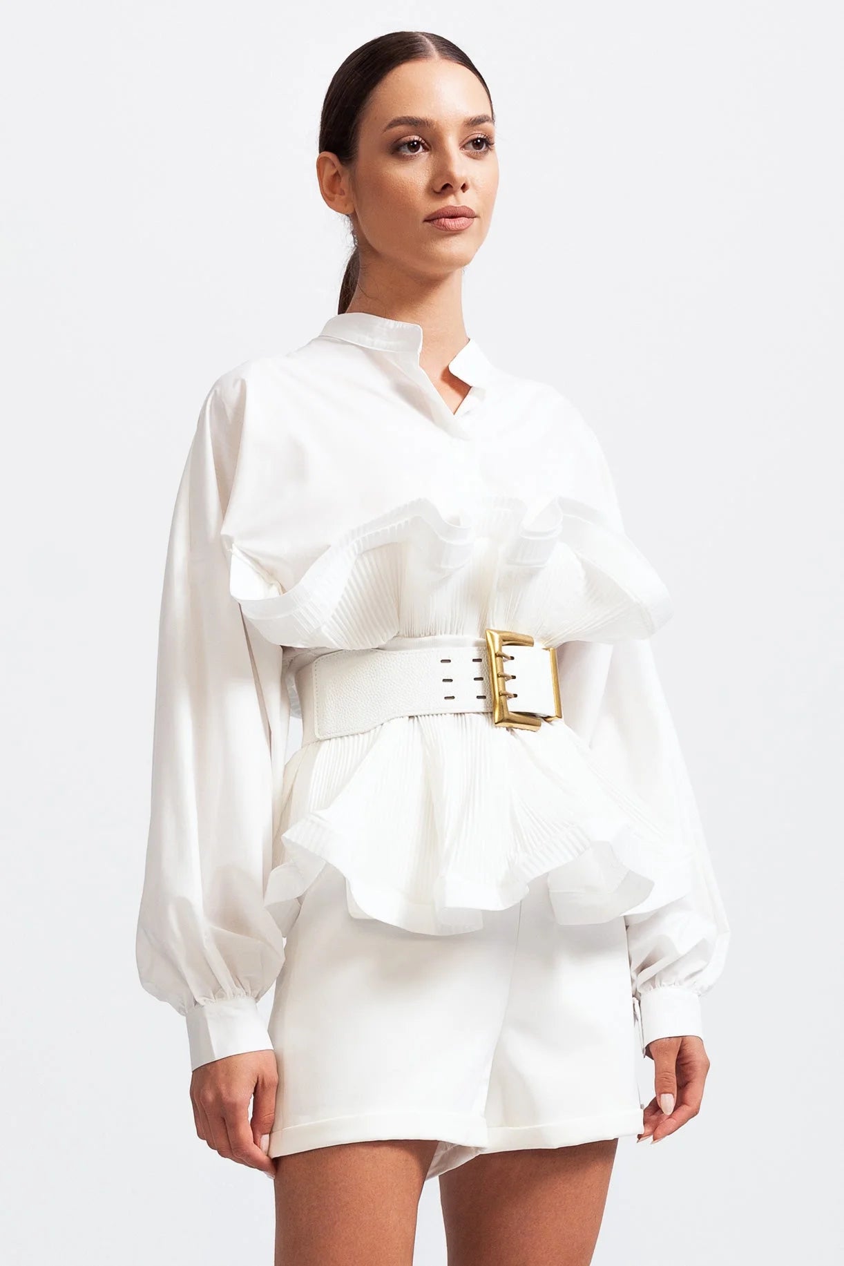 Women's ruffled belted shirt with voluminous sleeves in lightweight cotton, featuring a gathered neckline and stylish cuffs.