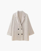 Women's relaxed fit satin jacket and pants set in soft material, featuring a sleek design and comfortable silhouette.