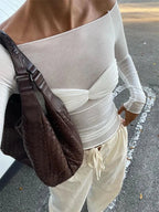 Lightweight sheer fabric off-shoulder top with ruched detailing, perfect for layering or casual wear.