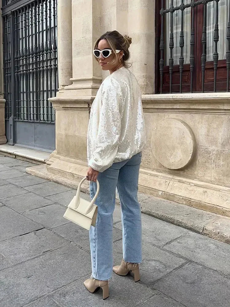Women's ivory jacket featuring shimmering sequins, a zip closure, and a stylish design perfect for evening wear.