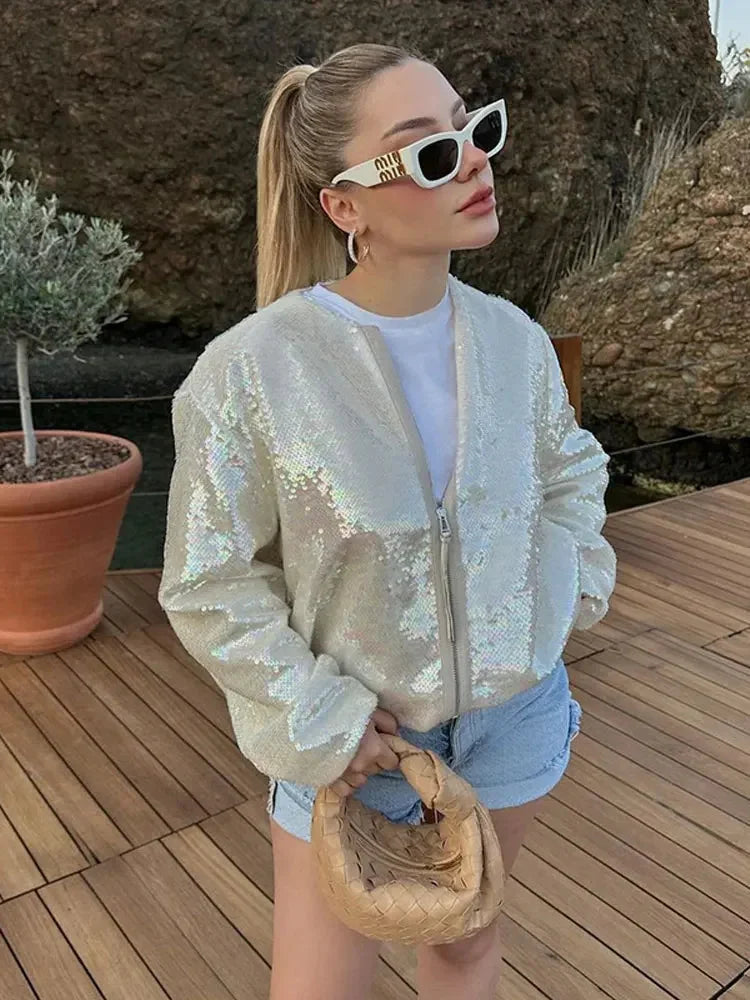 Women's ivory jacket featuring sequins, a zip closure, and a shimmering finish, perfect for adding sparkle to any outfit.