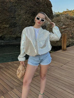 Women's ivory jacket with sequins, featuring a zip closure and a shimmering finish, crafted for a stylish look.