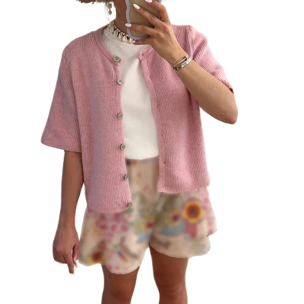 Women's short sleeve button-up cardigan made of soft cotton blend, featuring a classic collar and stylish pocket detailing.
