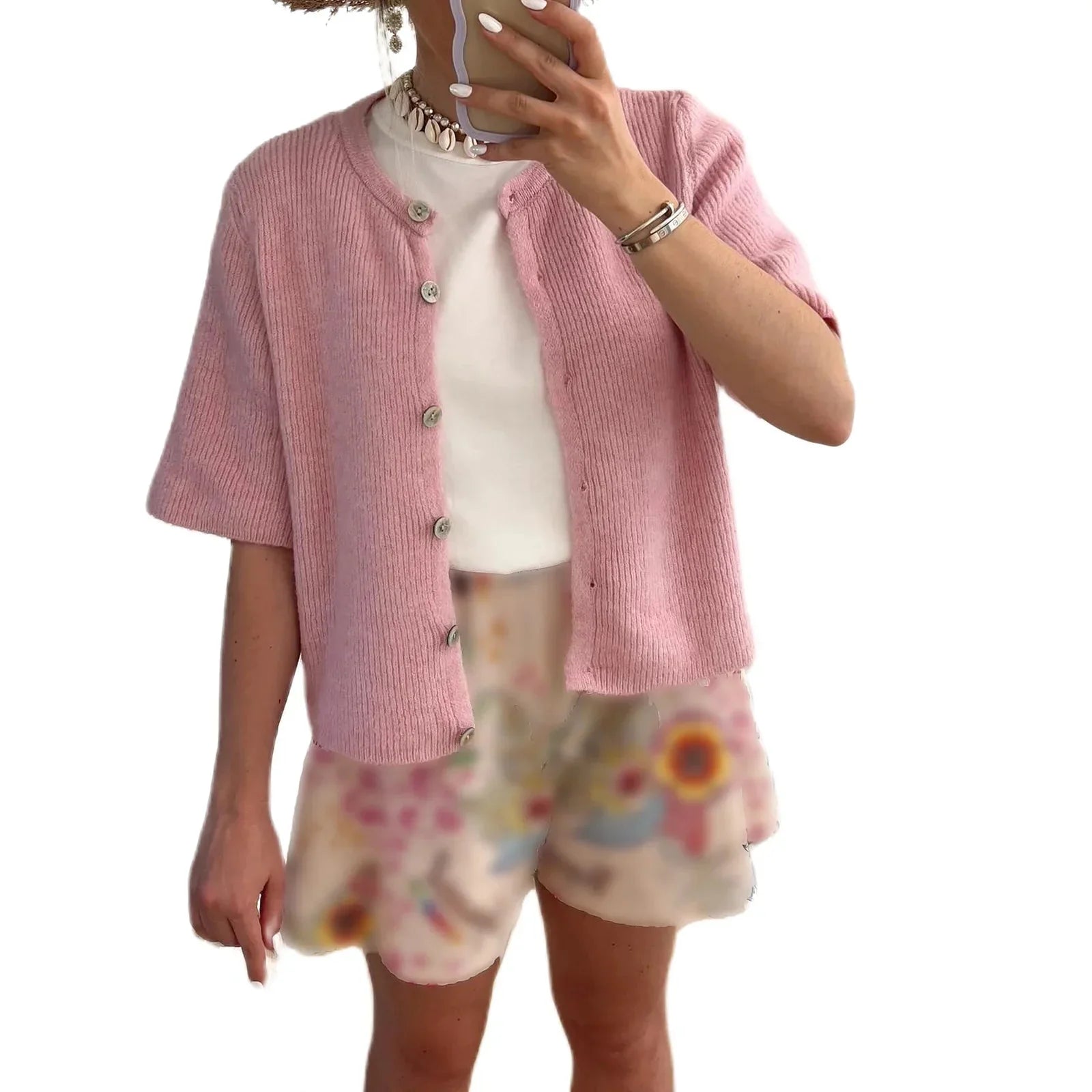 Women's short sleeve button-up cardigan made of soft cotton blend, featuring a classic collar and stylish pocket detailing.