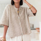 Women's short sleeve button-up cardigan in soft cotton blend, featuring a lightweight design and classic button front for…