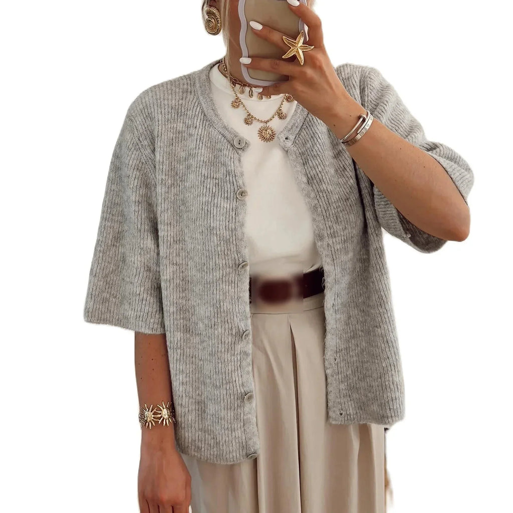 Women's short sleeve button-up cardigan made from soft cotton blend, featuring a classic design and practical front buttons.