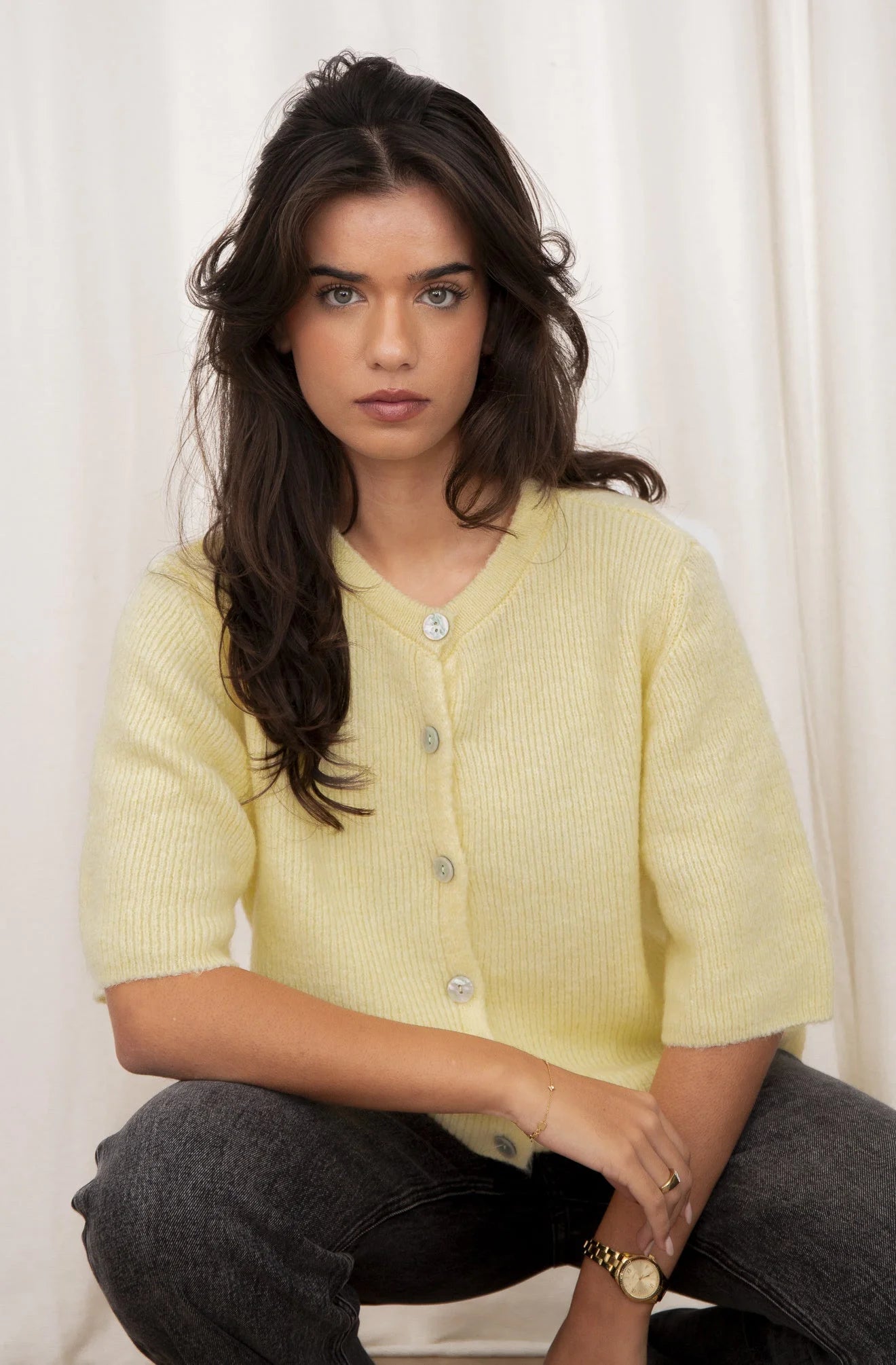 Women's short sleeve button-up cardigan made from soft cotton blend, featuring a relaxed fit and classic collar design.