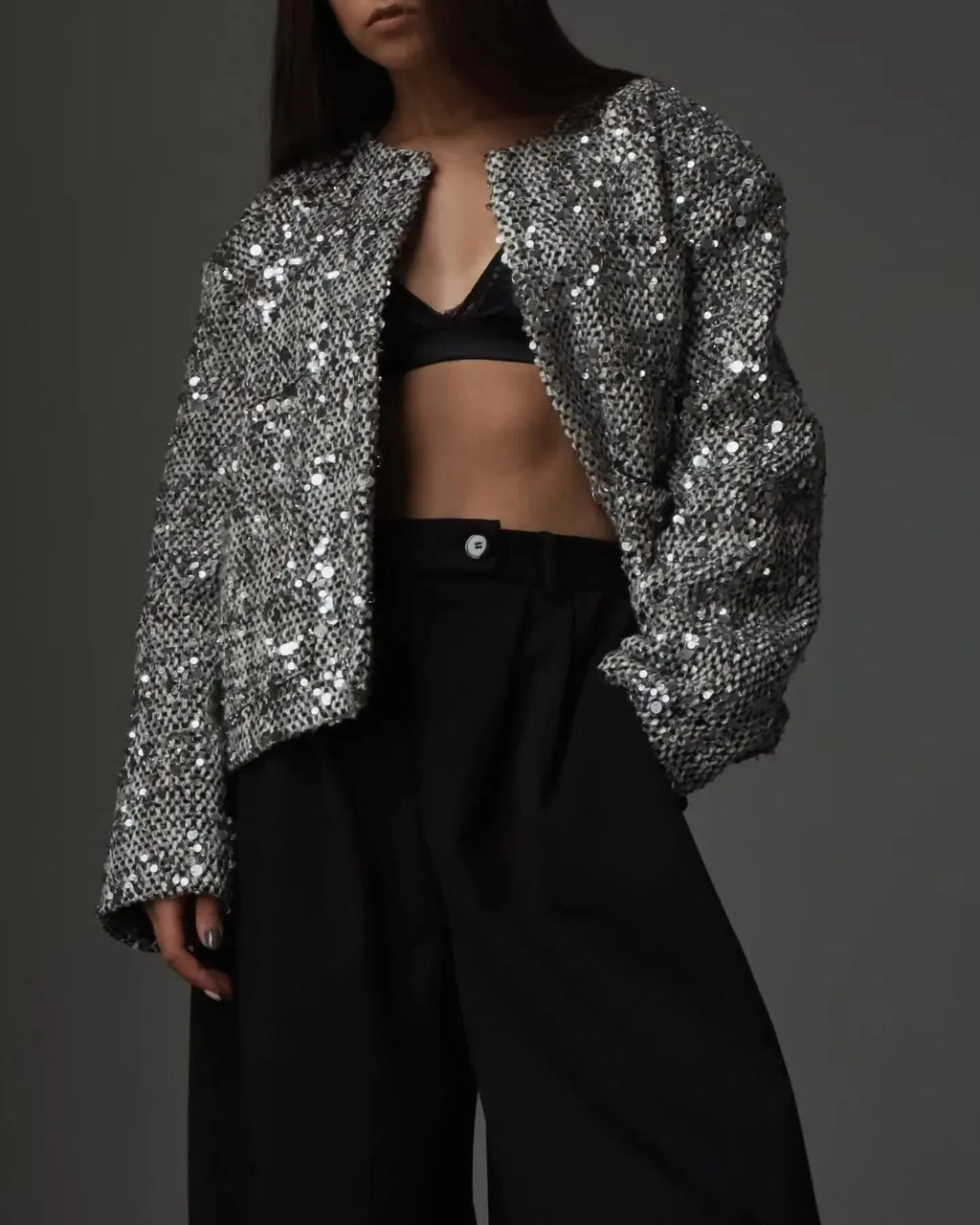 Women's open front jacket made of silver sequins, featuring a stylish design for a shimmering, eye-catching look.