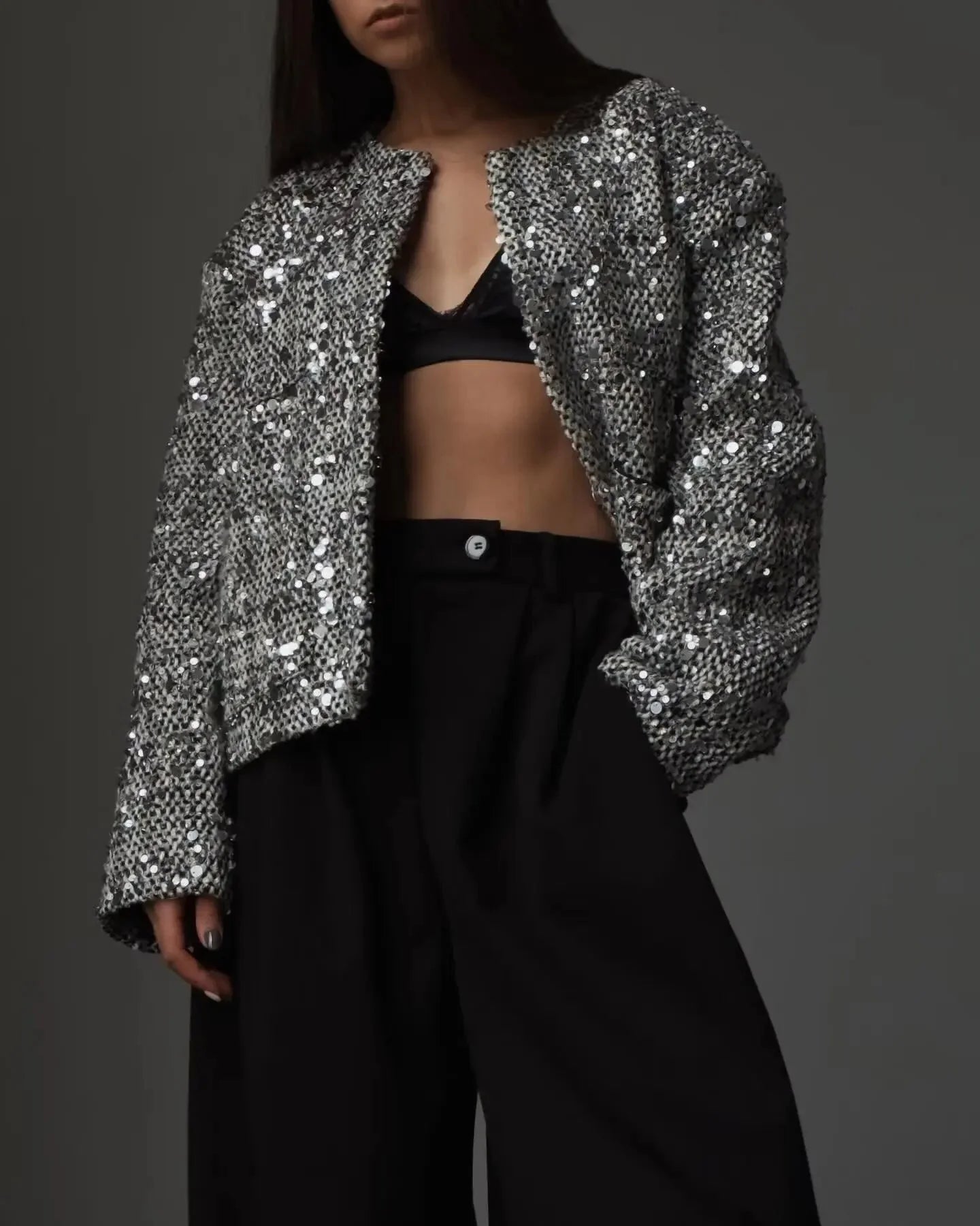 Women's open front jacket made of silver sequins, featuring a stylish design for a shimmering, eye-catching look.
