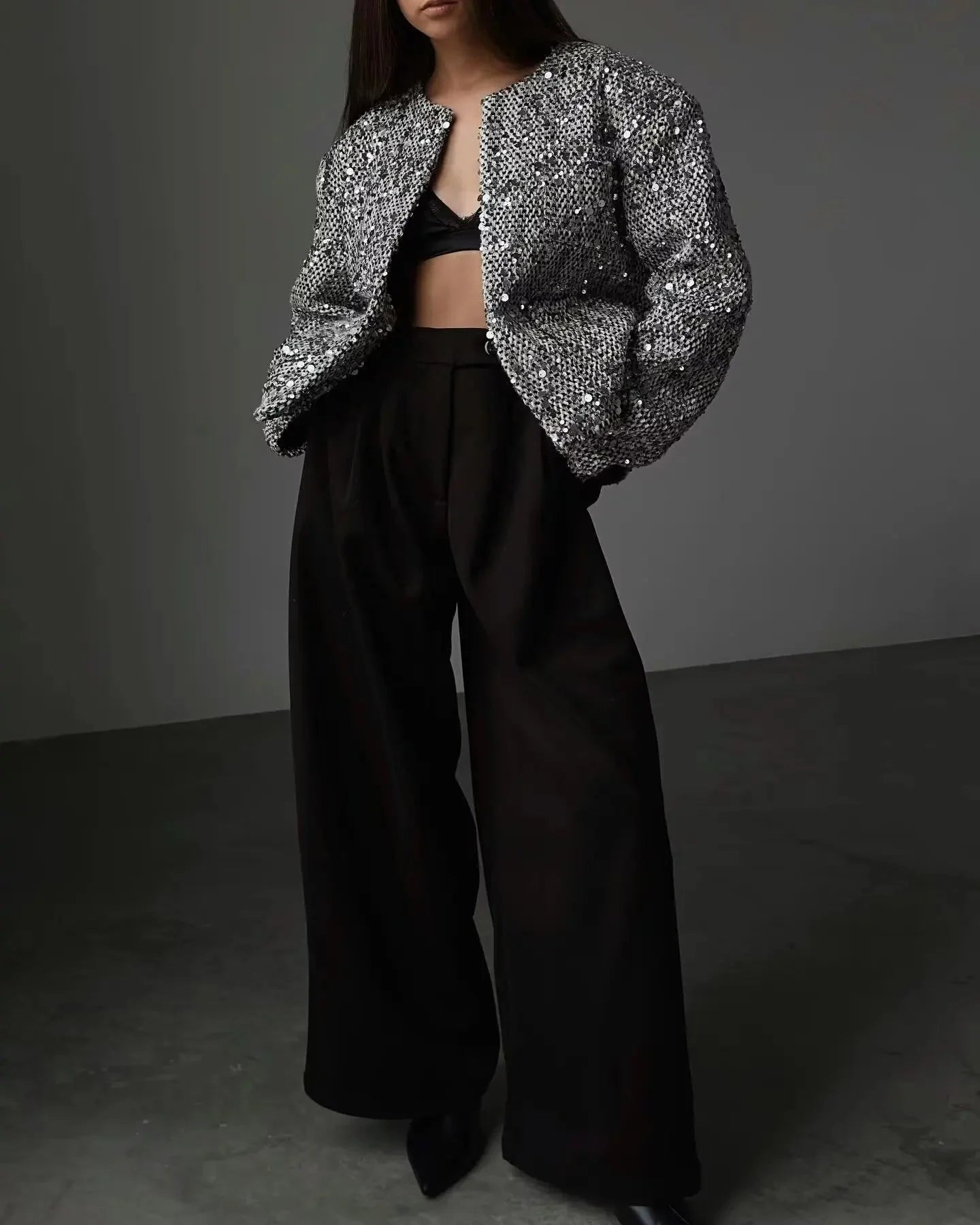 Women's silver sequin open front jacket featuring a sparkling design and lightweight material, perfect for layering on any…